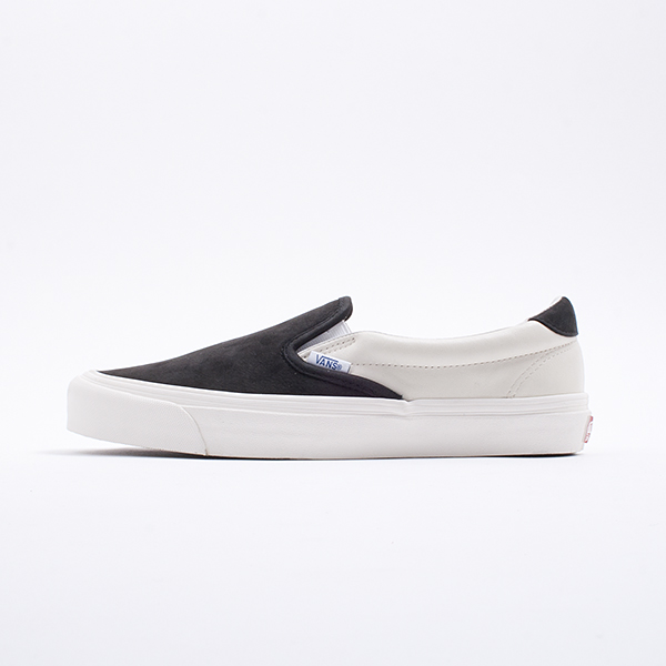 black and cream slip on vans